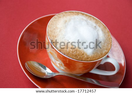 A good start to any day... fresh cappuccino-on the red background