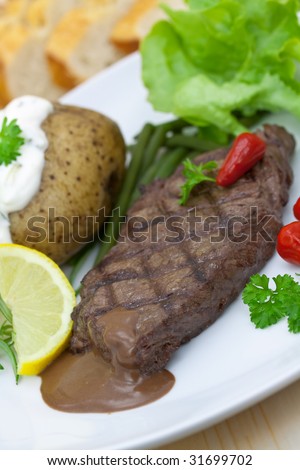 sirloin strip steak with vegetables and savory sauce