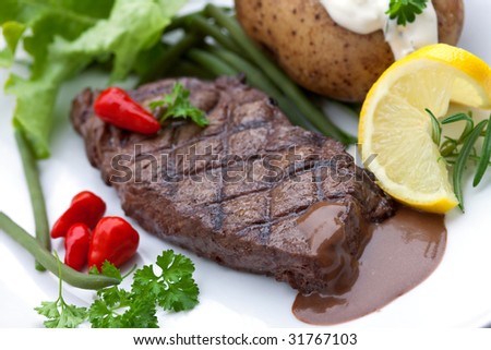 a sirloin strip steak with vegetables and savory sauce