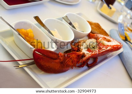 Image of lobsters ,fresh roasted on a grill,with sauce bechamel