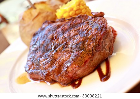 sirloin strip steak with corn cob ,vegetables and savory sauce