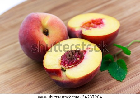 ripe half of peach, on wooden background