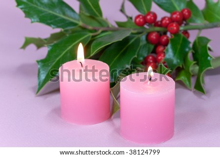 christmas decoration with candle light,holly leaves and berries