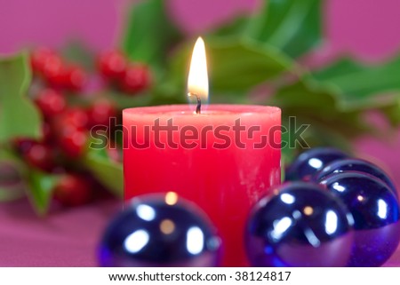 christmas decoration with candle light,holly leaves and berries