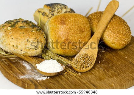 german roll bread with pumpkin and poppy seeds on the white background