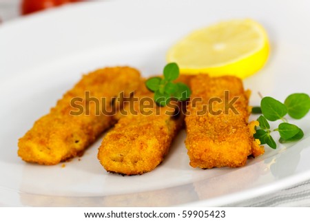 three fish fingers and slice of lemon