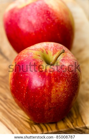 two apples on wooden table in garden