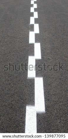 Asphalt with two white dashed lines