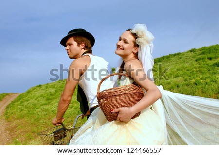 Bride and groom with the chicken in the village