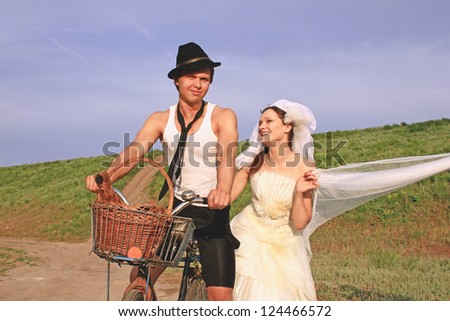 Bride and groom with the chicken in the village