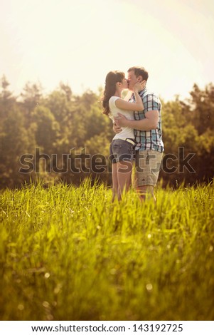 The loving couple walks in the field