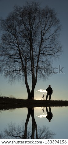 man and tree in the back lighting at the park
