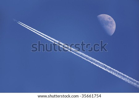 An airplane flying near the moon in the afternoon