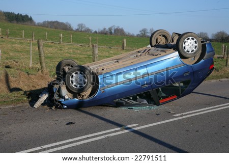 Car on roof after road accident but driver survived