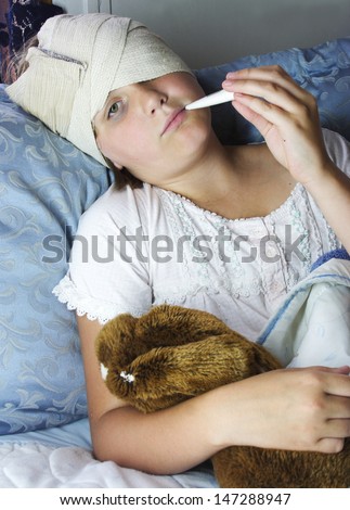 Sick in bed with a teddy bear