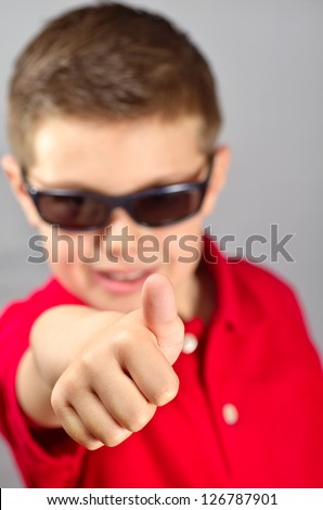 portrait of a boy with sunglasses and red sweater