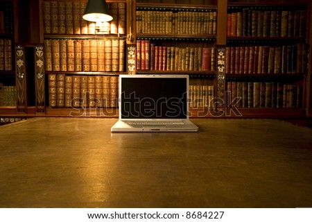 Laptop in classic library with books in background series