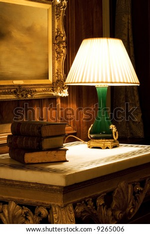Old night lamp on the table with books