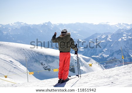 Skier photographing beautiful landscape.