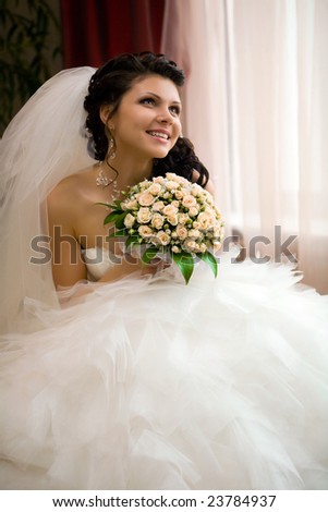 Smiling bride with the bouquet Focus point on the face & bouquet Smiling bride with the bouquet Focus point on the face & bouquet