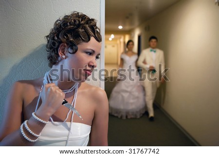 Pretty bride with the knife is waiting for unfaithful husband.