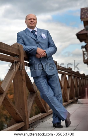 Portrait of a serious groom on the blurred background. Focus point on the groom\'s face.
