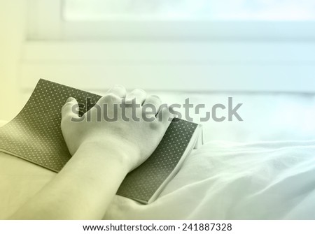 Young woman sleeping with book on the bed. Vintage style.