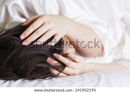 Sick woman on the bed at home