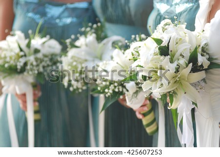 bouquet with hands holding in wedding celebration, soft tone with selective focus