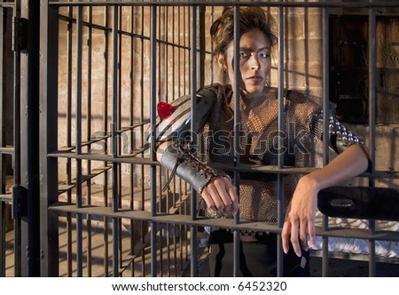 Tough science-fiction woman behind bars in a retro jail.