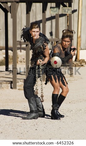 Tough science-fiction women in costumes with weapons.
