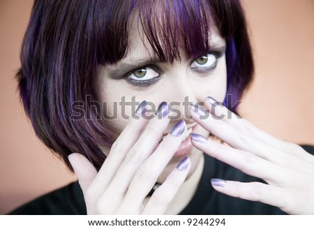 Alternative Young Woman with Her hands in Front of Her Face