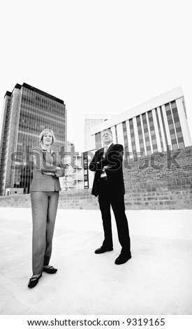 executive man and woman on a downtown roof