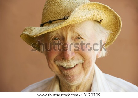 Senior Citizen Man Smiling in a Straw Cowboy Hat