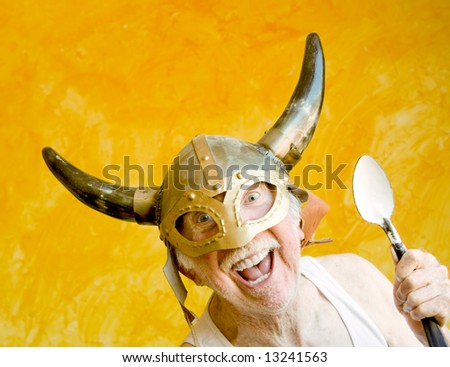 stock photo Crazy Old Man in a TeeShirt and a Viking Helmet