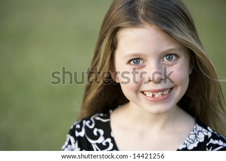 Pretty Young Girl with Freckles and a Big Smile and Crooked Teeth