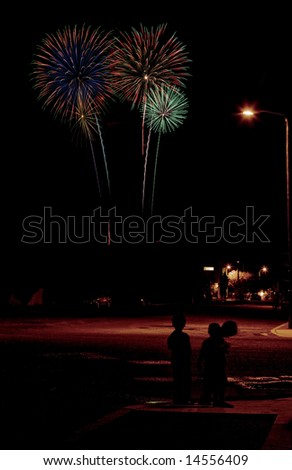Long exposure of fireworks over an urban street scene