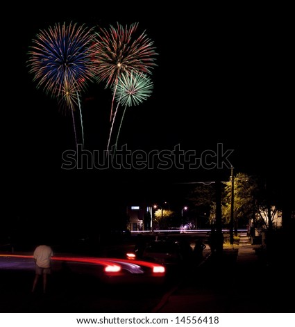 Long exposure of fireworks over an urban street scene