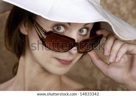 Young Woman with Sunglasses and a Floppy White Hat