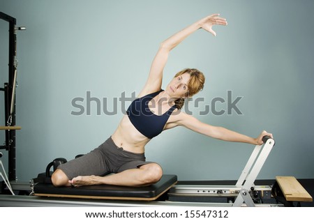 Pretty Woman Working Out on Pilates Equipment