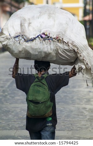 Nicaraguan man carrying a large package on his head