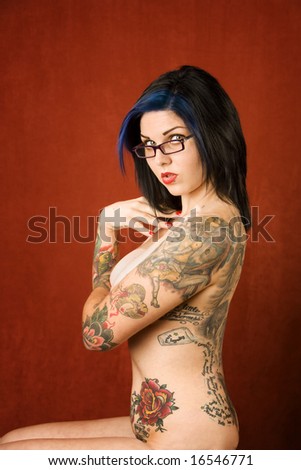 coat of arms tattoo. woman with many tattoos on