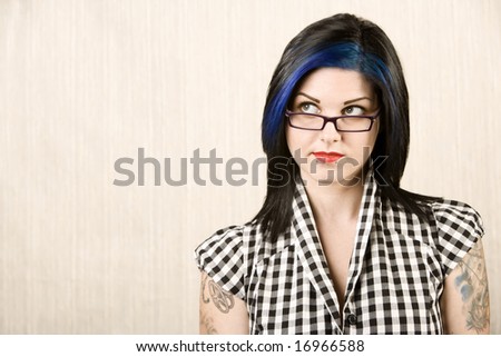 stock photo Portrait of a cute rockabilly woman with tattoos on her arms