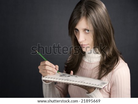 Pretty female artist with pencil and drawing pad