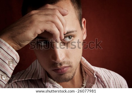 Young man with stubble in serious thought