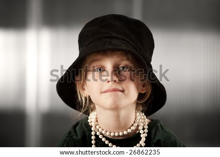 Funny young girl wearing a big floppy hat