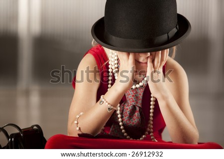 Funny young girl with her face hidden in her hat