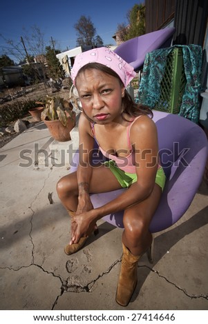 Black woman in front of house with messy yard