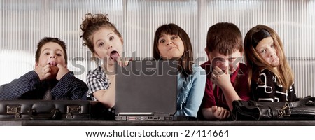 Kids posing as a professional business team making funny faces