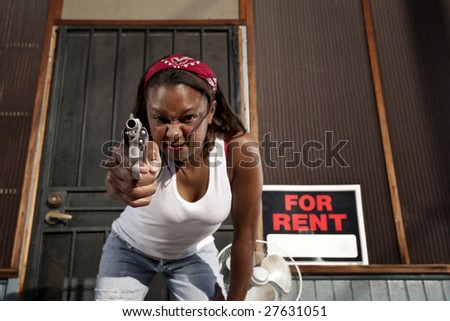 African American woman with a gun on her front porch